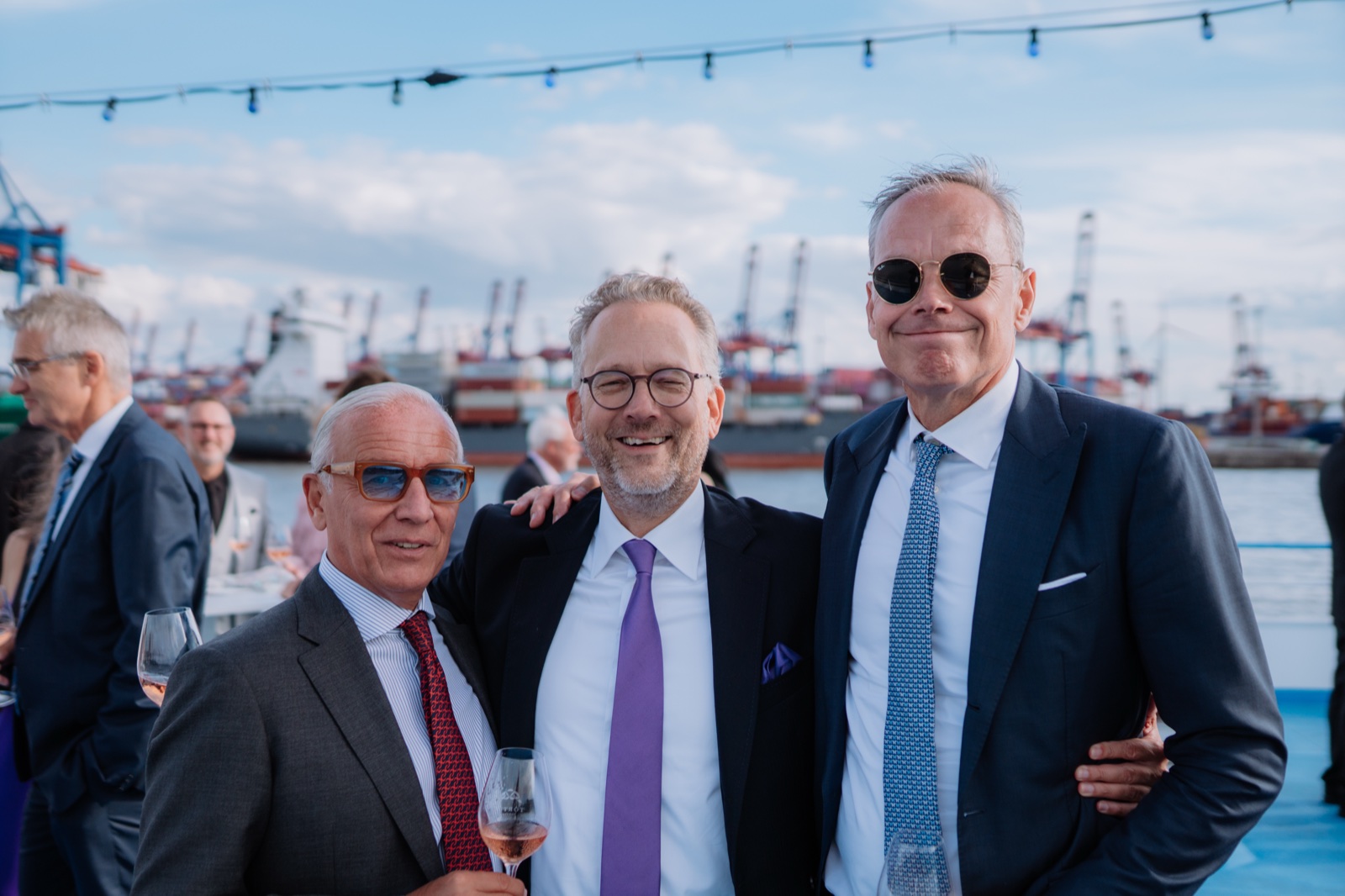 Wedding guests on deck against the Port of Hamburg